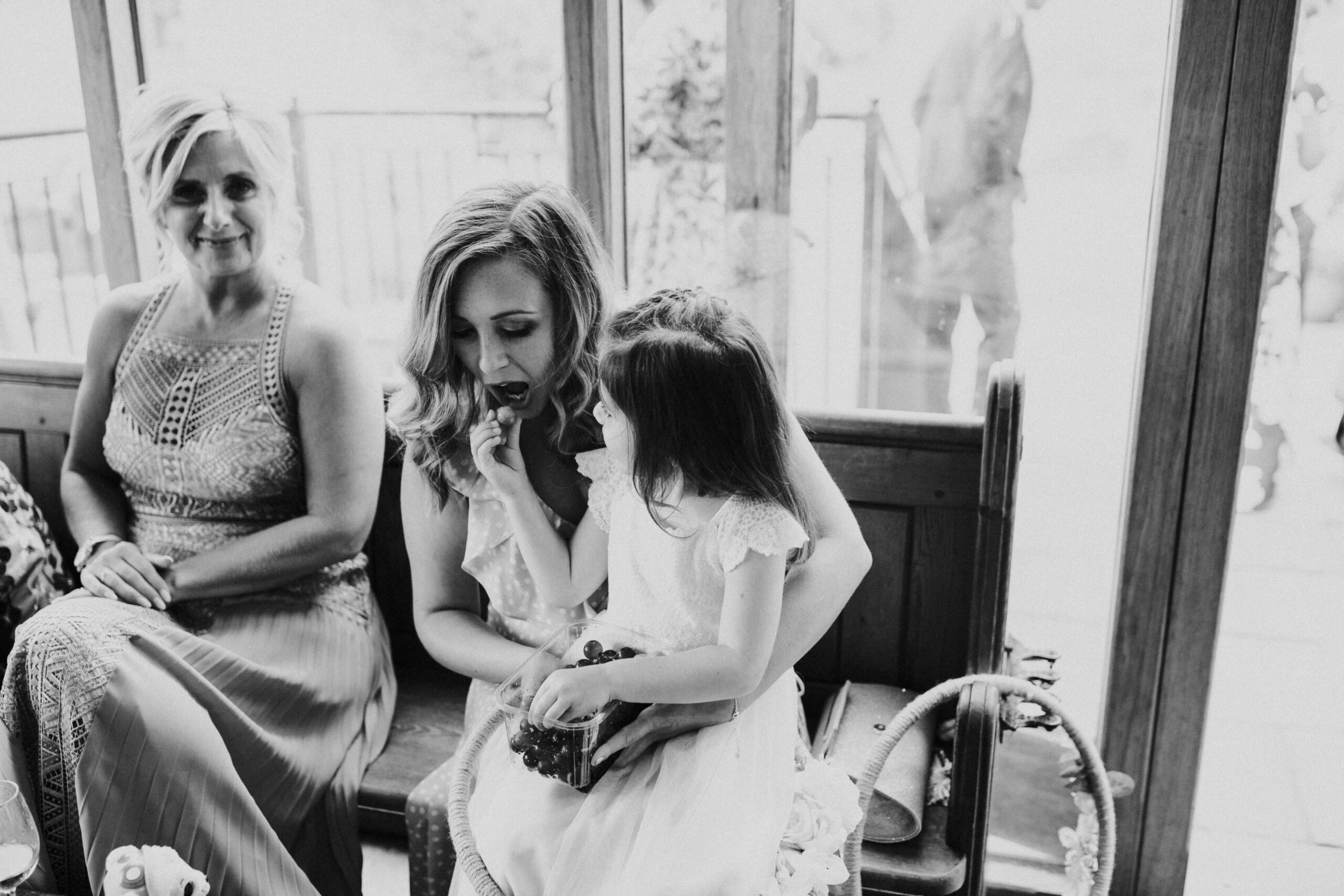 little girl feeding guest sweets 