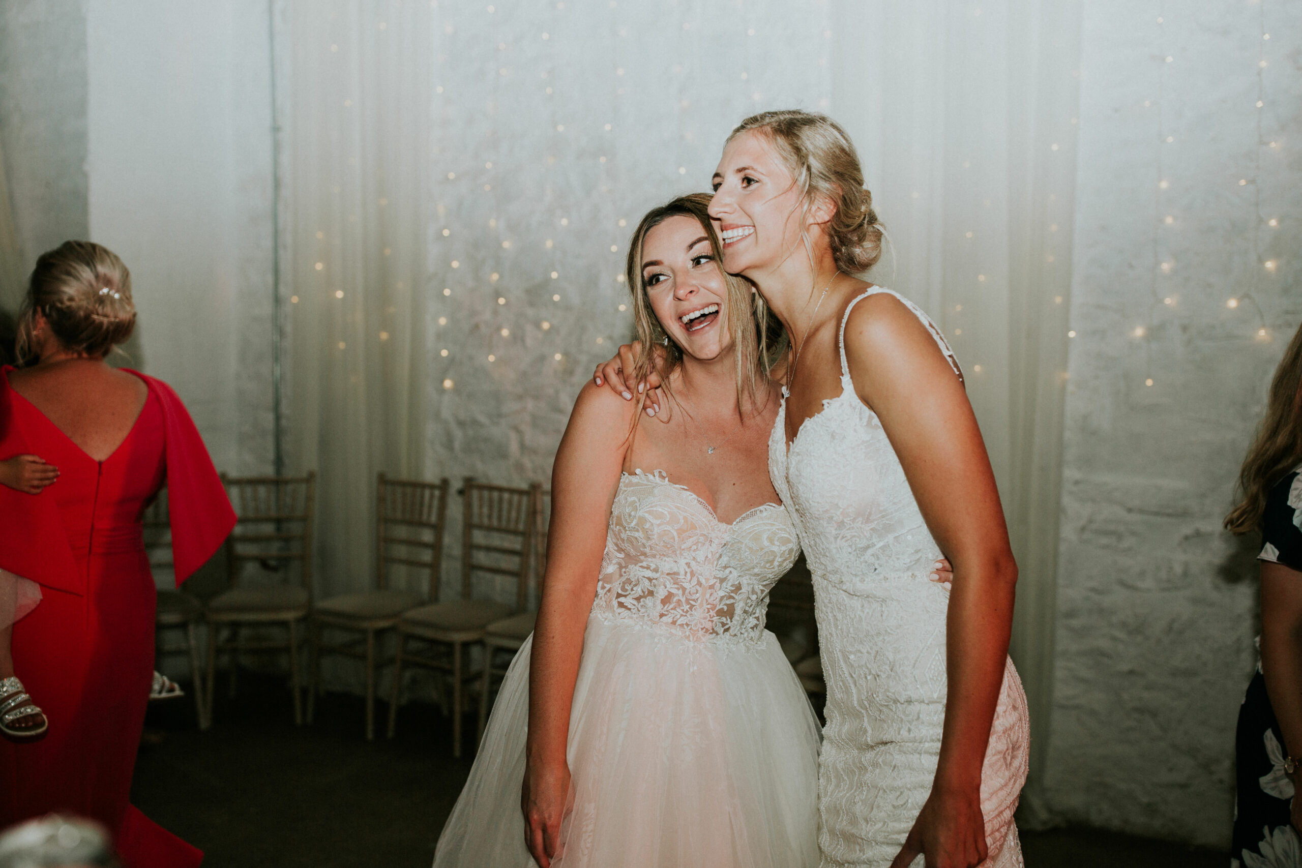 brides laughing on the dance floor 