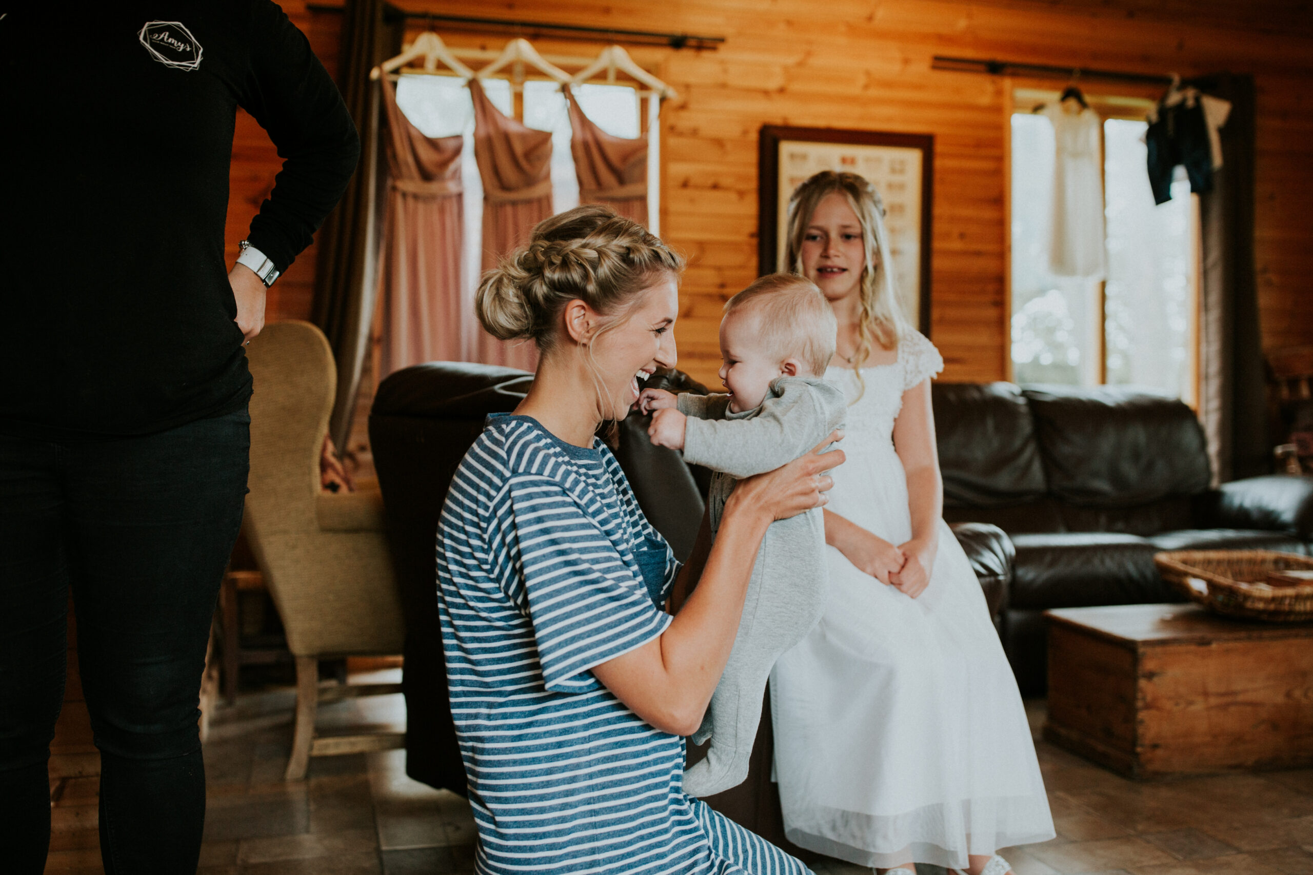 bride holding the baby in the air