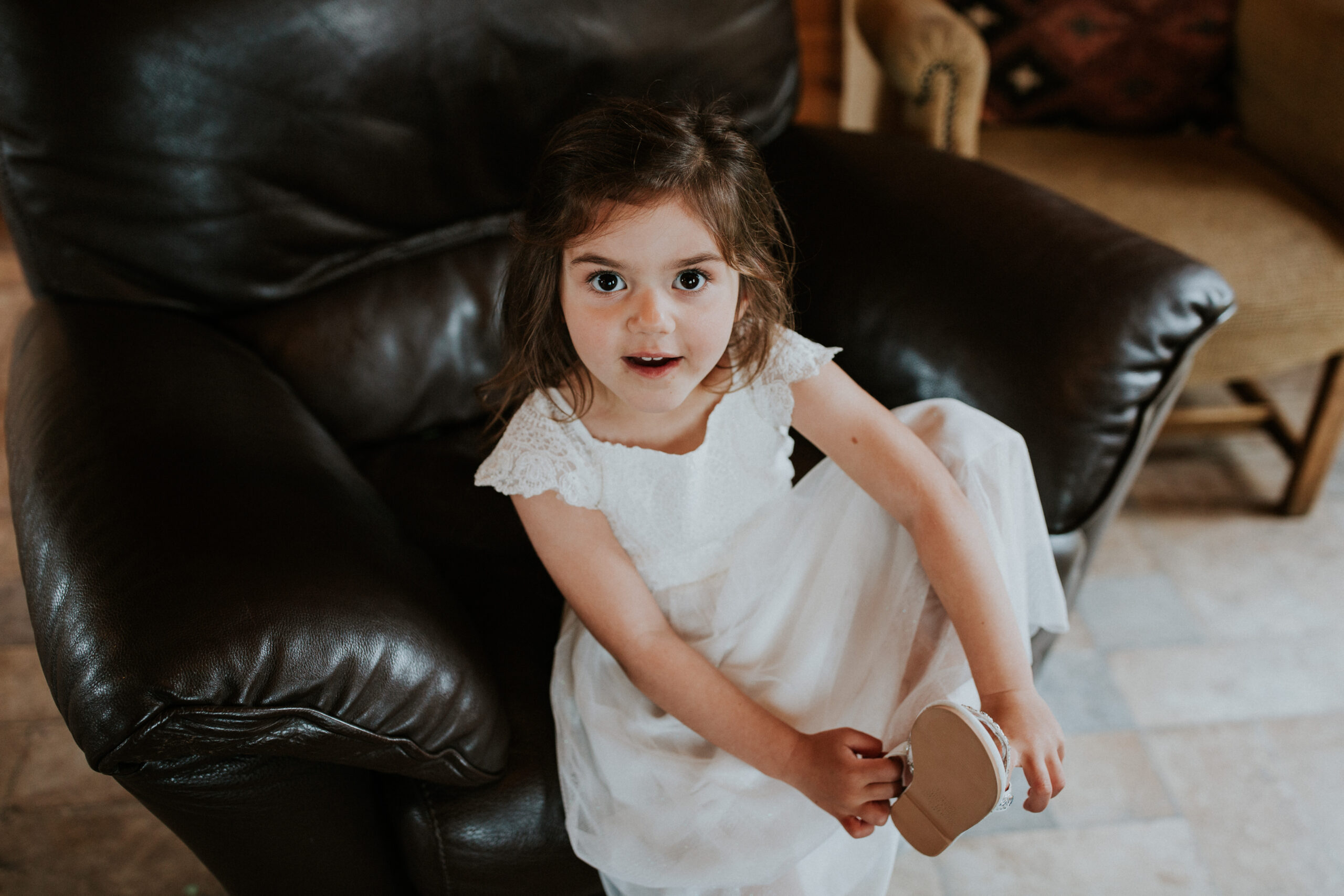 flower girl putting on her shoes