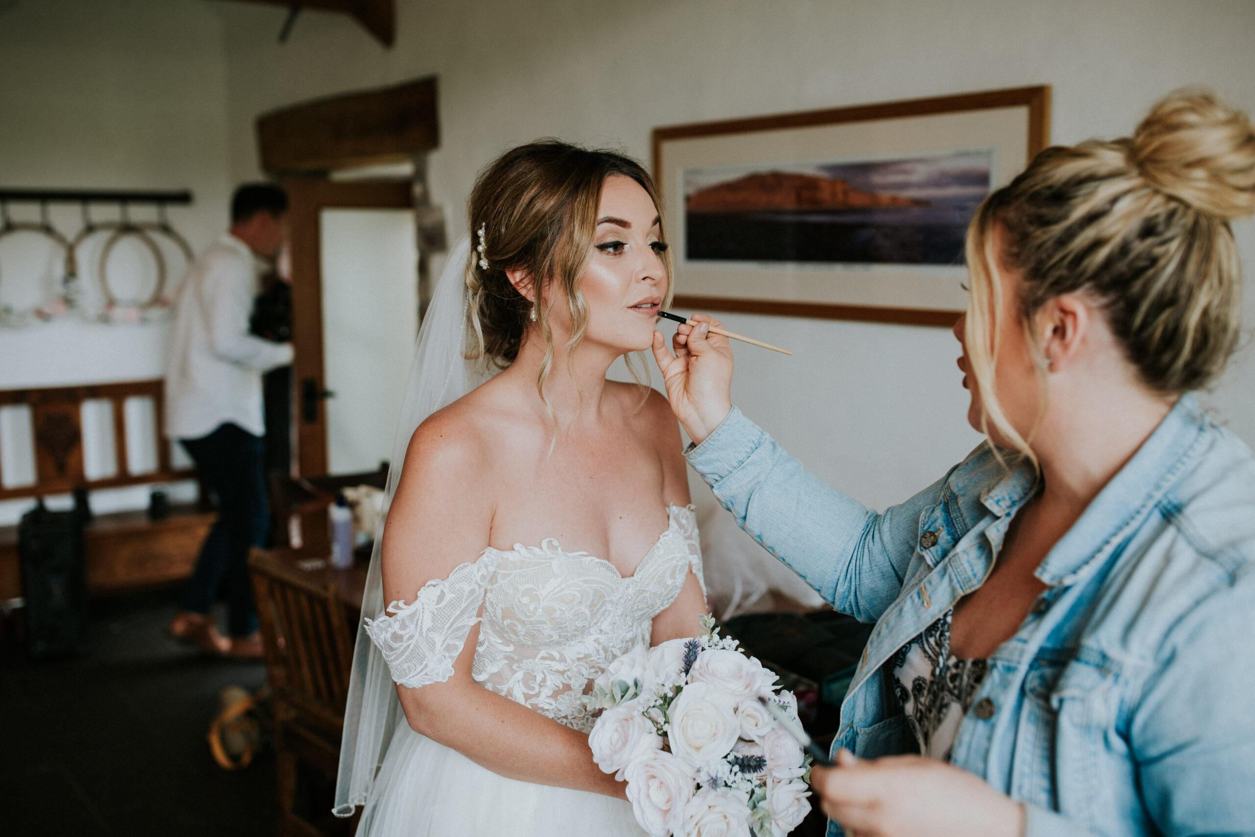 bride topping up her lipstick
