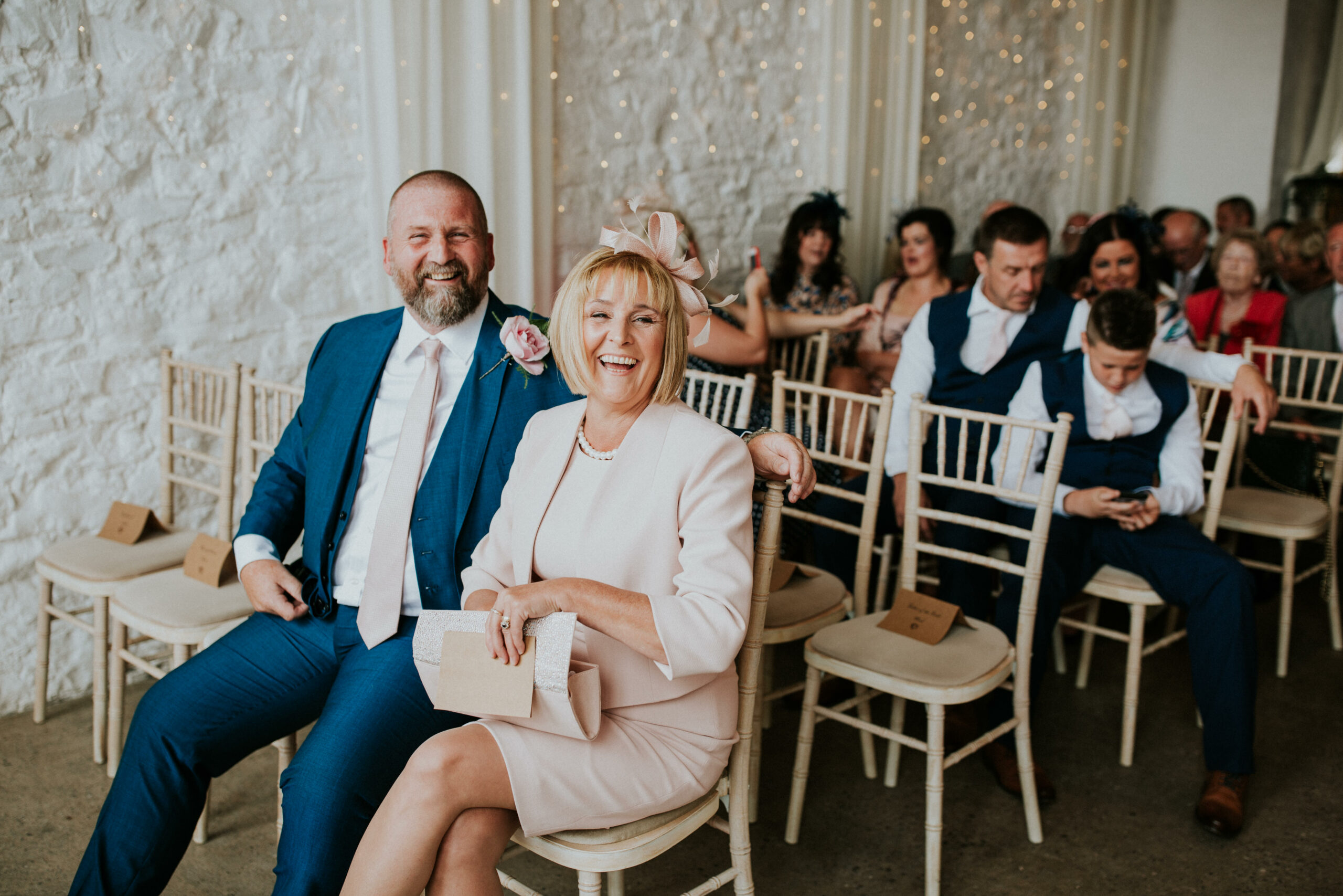 parents sitting in the ceremony smiling