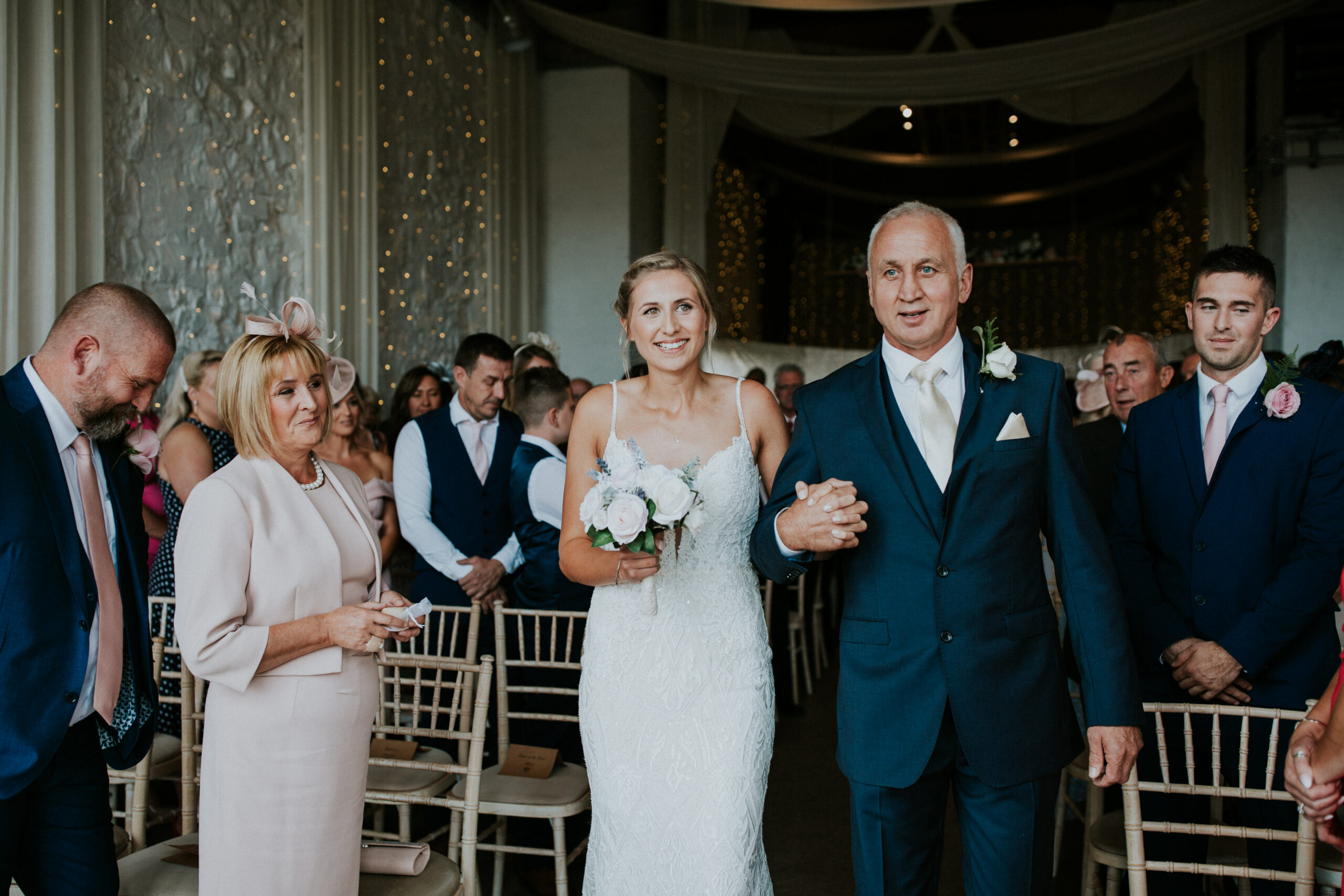 bride and her father walk down the aisle