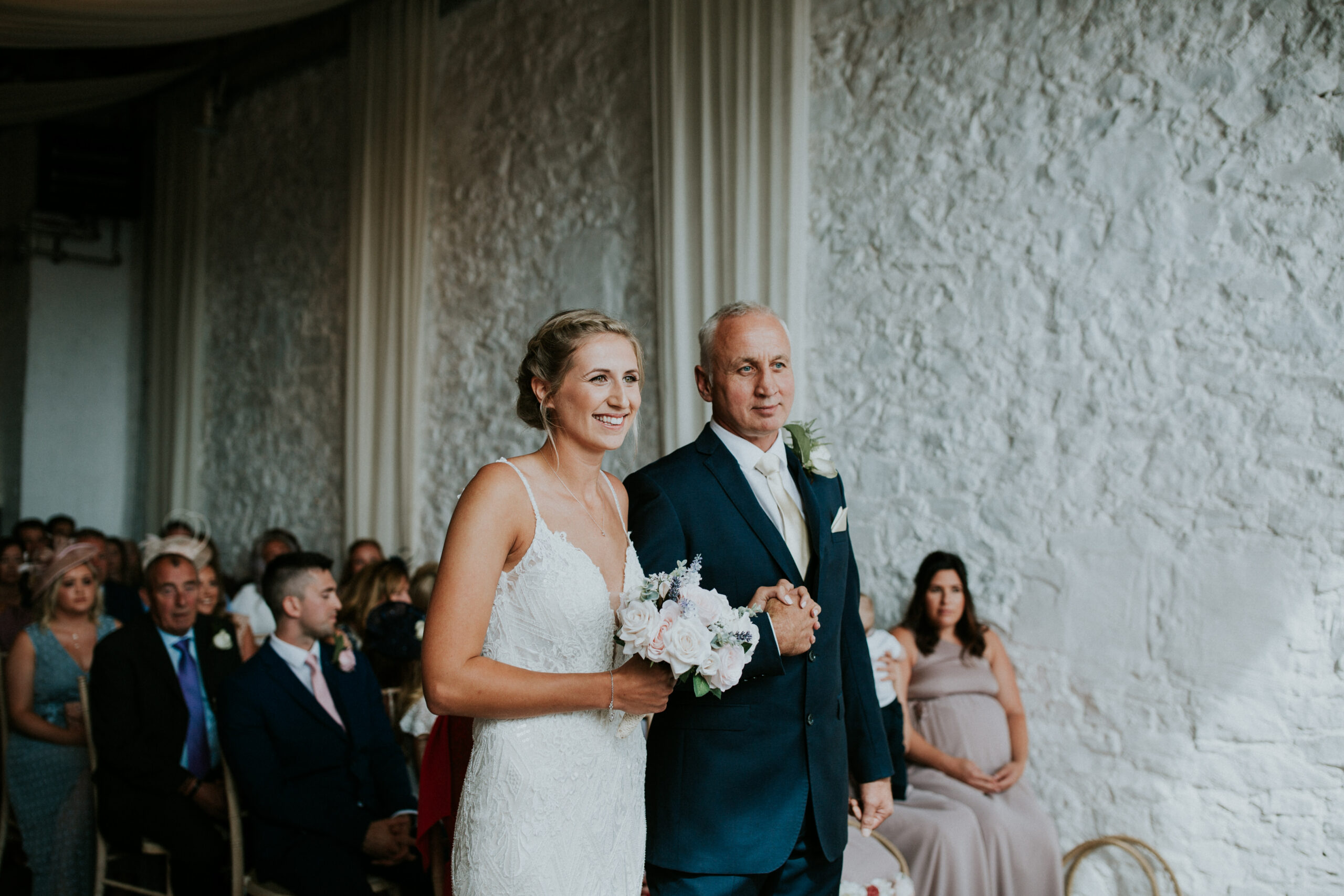 bride and father waiting at the end of the aisle