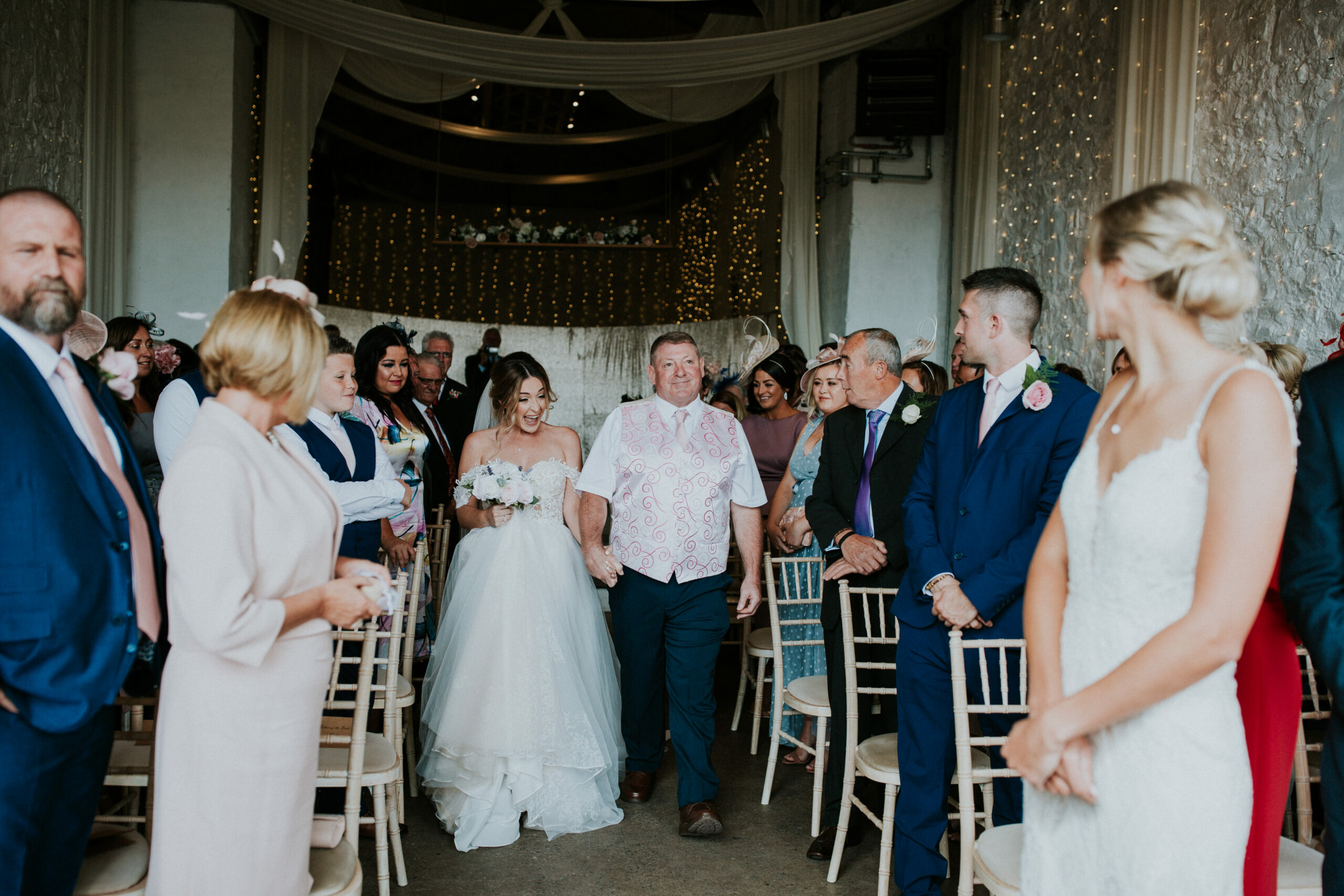 bride walking down the aisle with dad