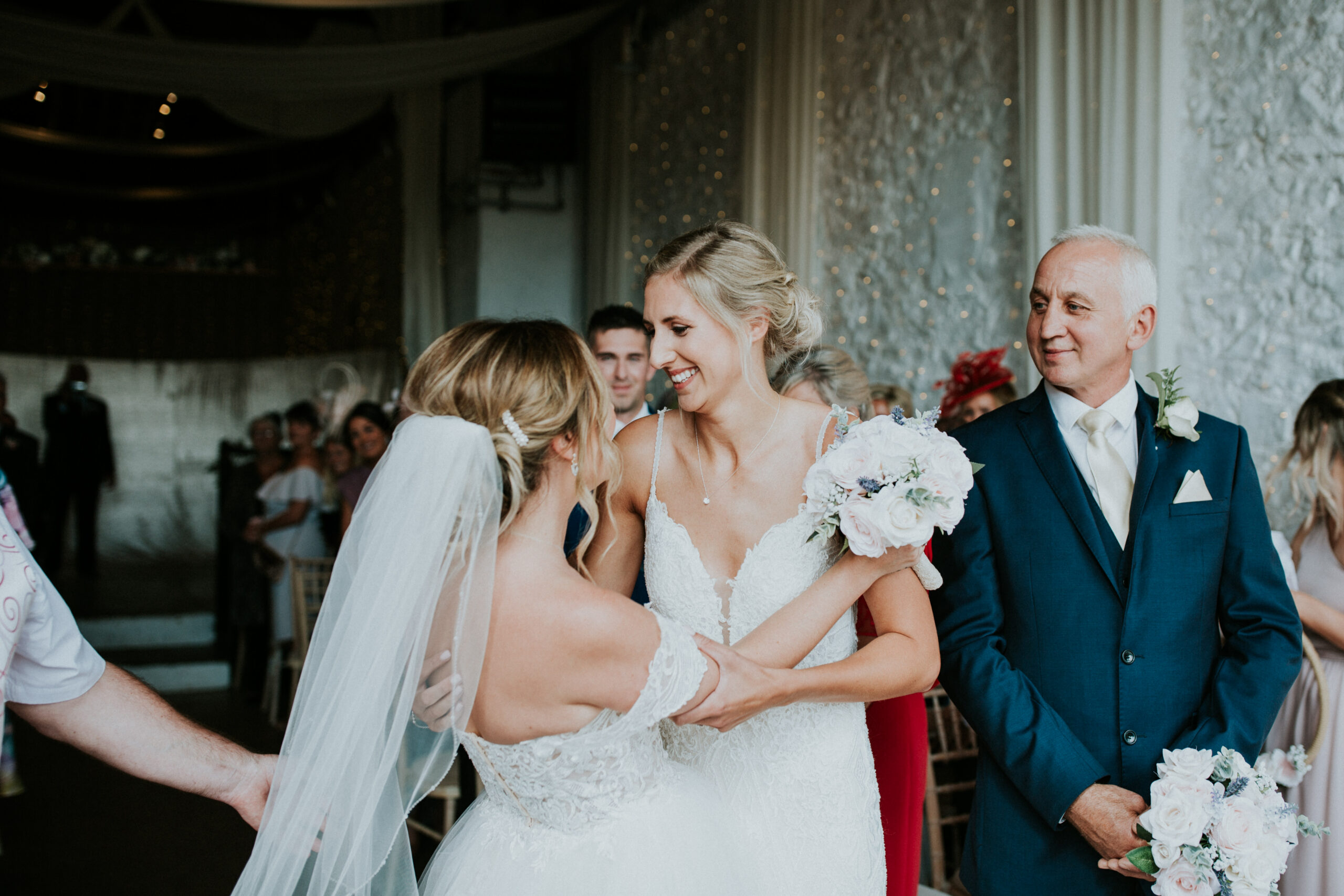 brides smiling at each other