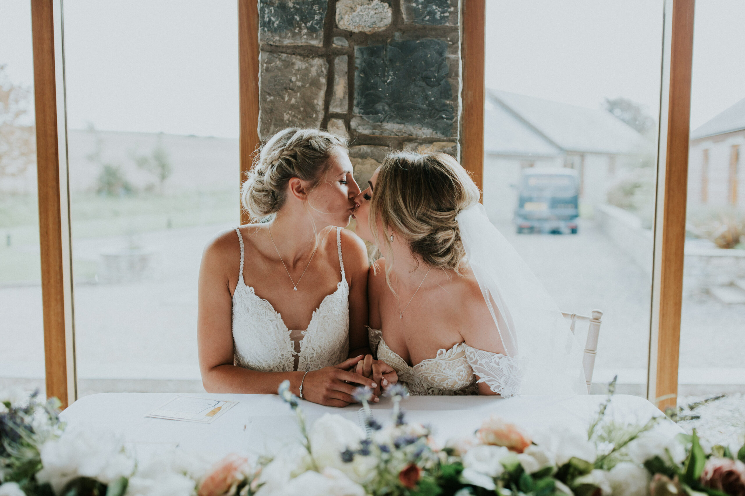 brides kissing signing the register 