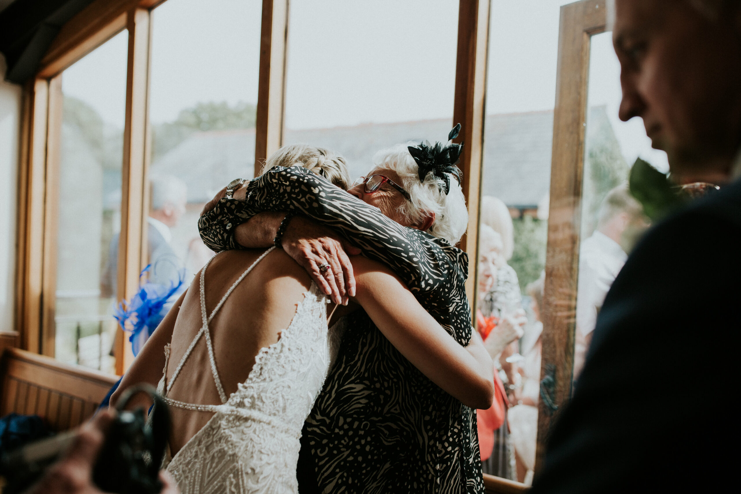 guest hugging a bride 
