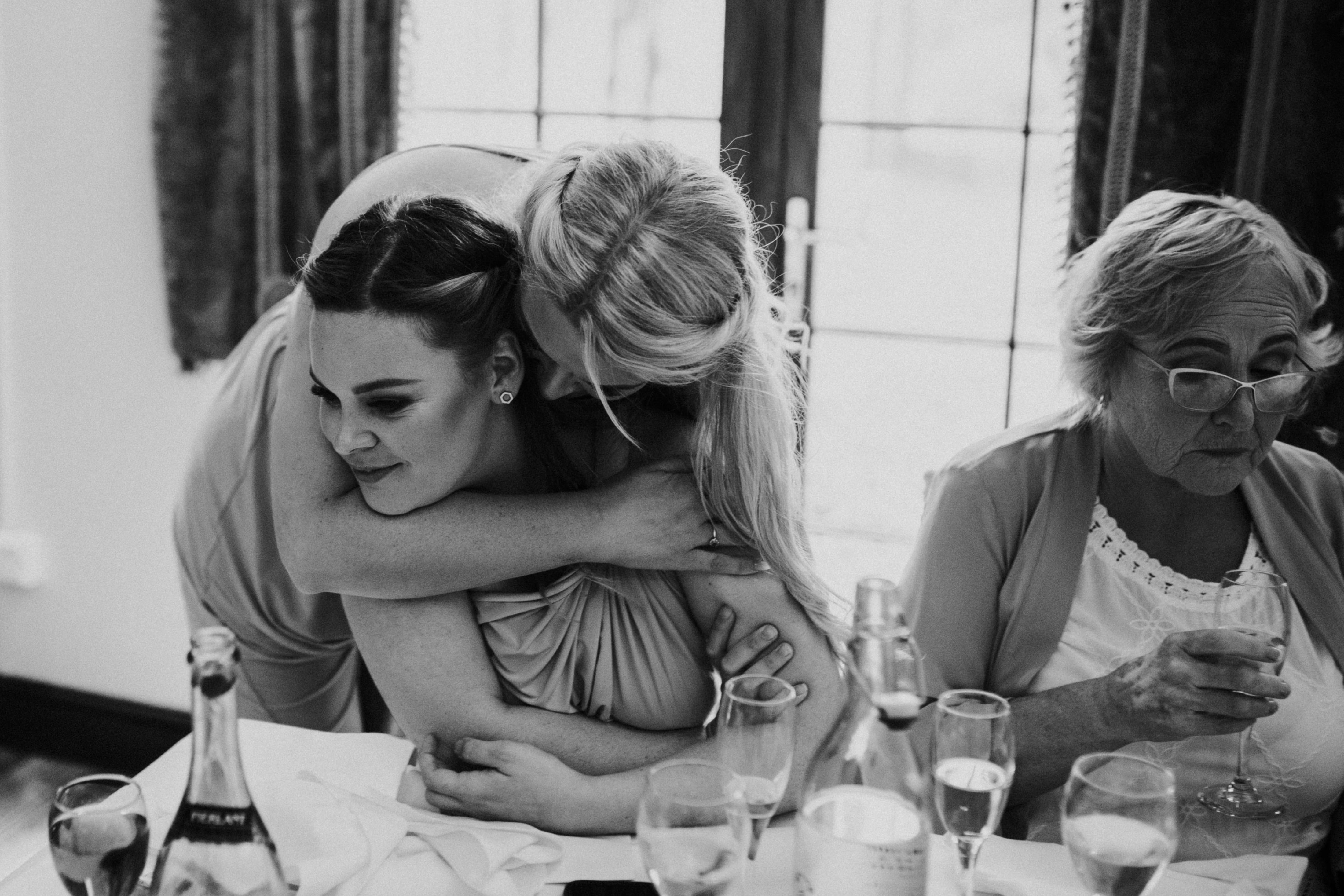 bridesmaids hugging each other 