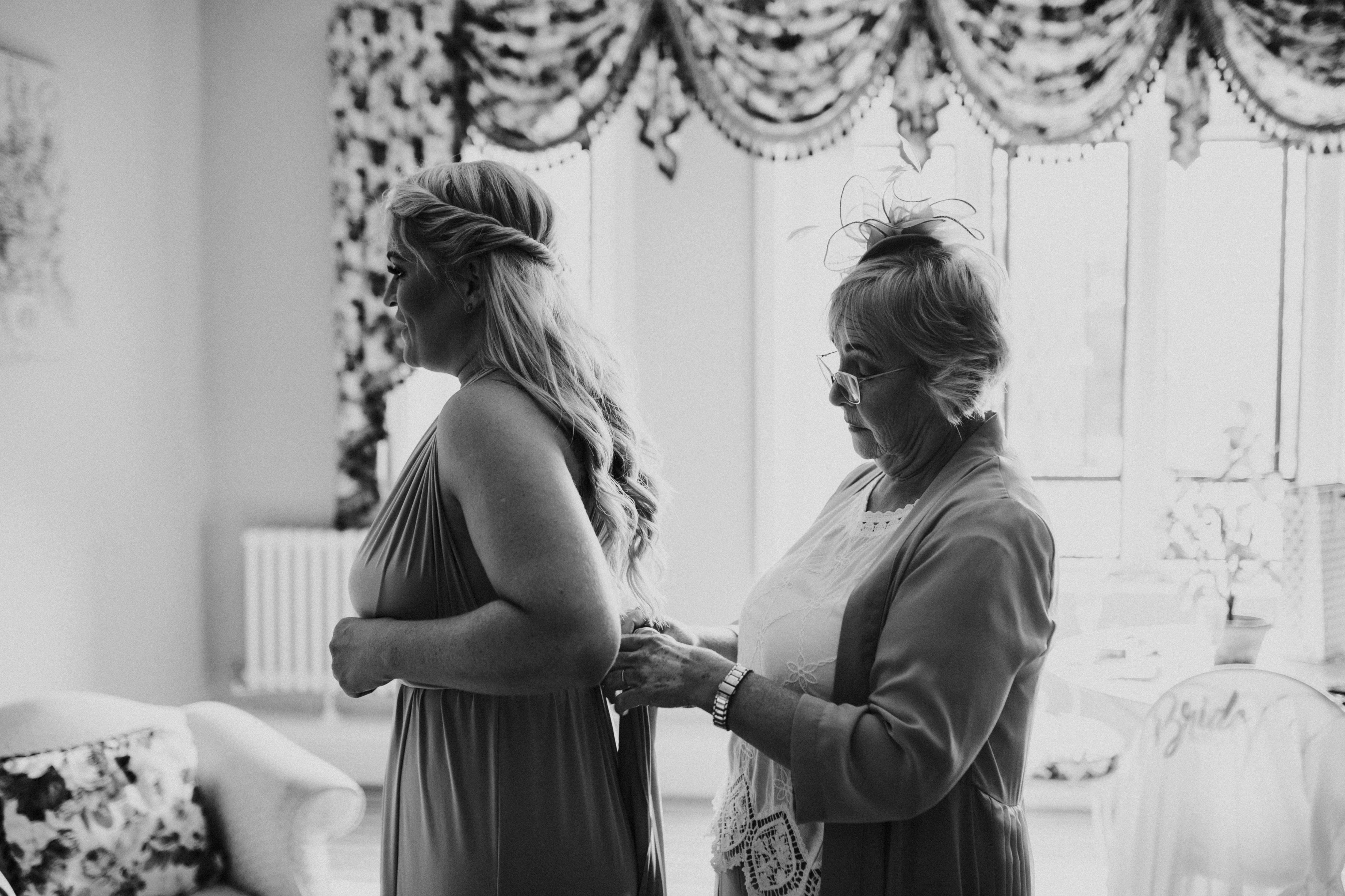 brides mum doing bridesmaids dress