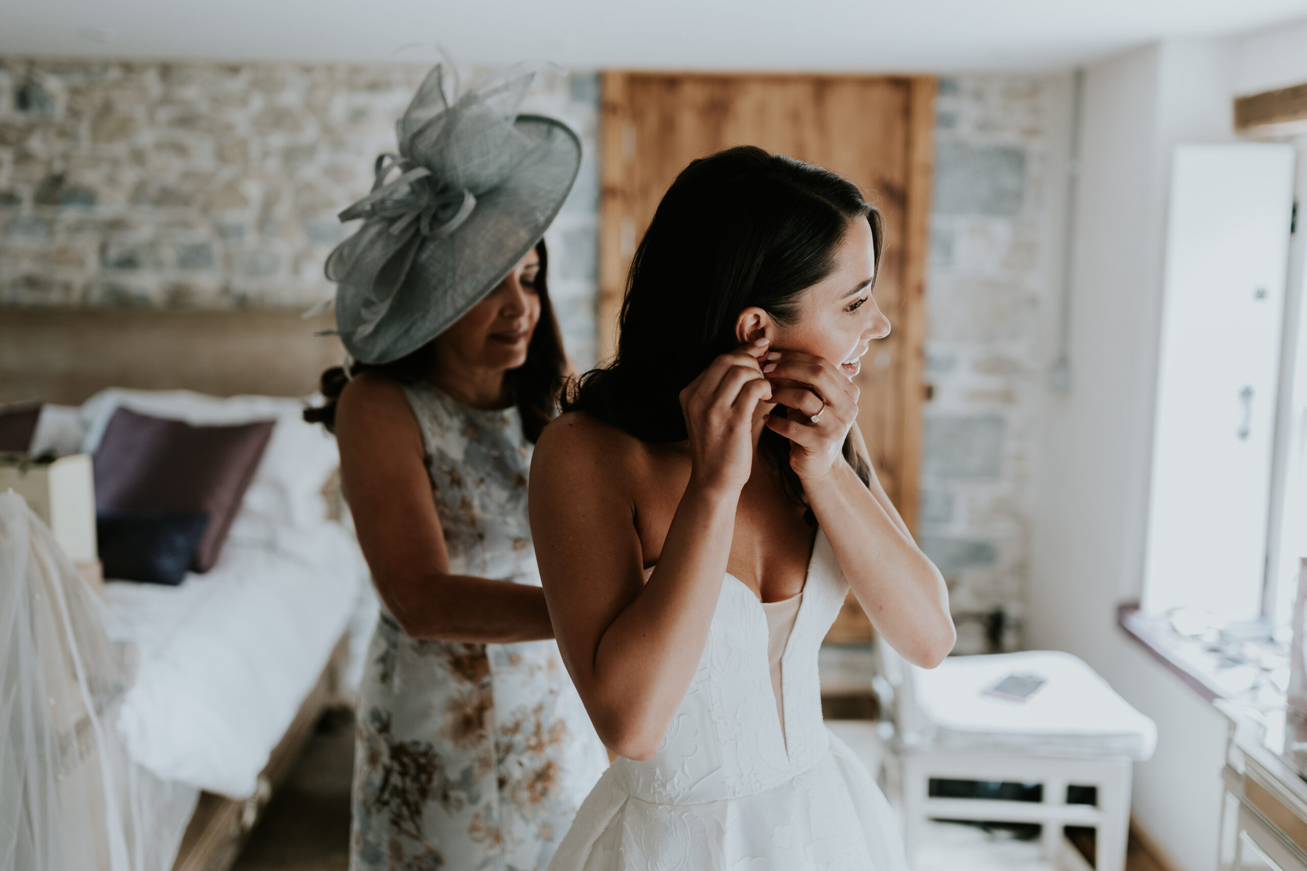 Bride putting earrings in 