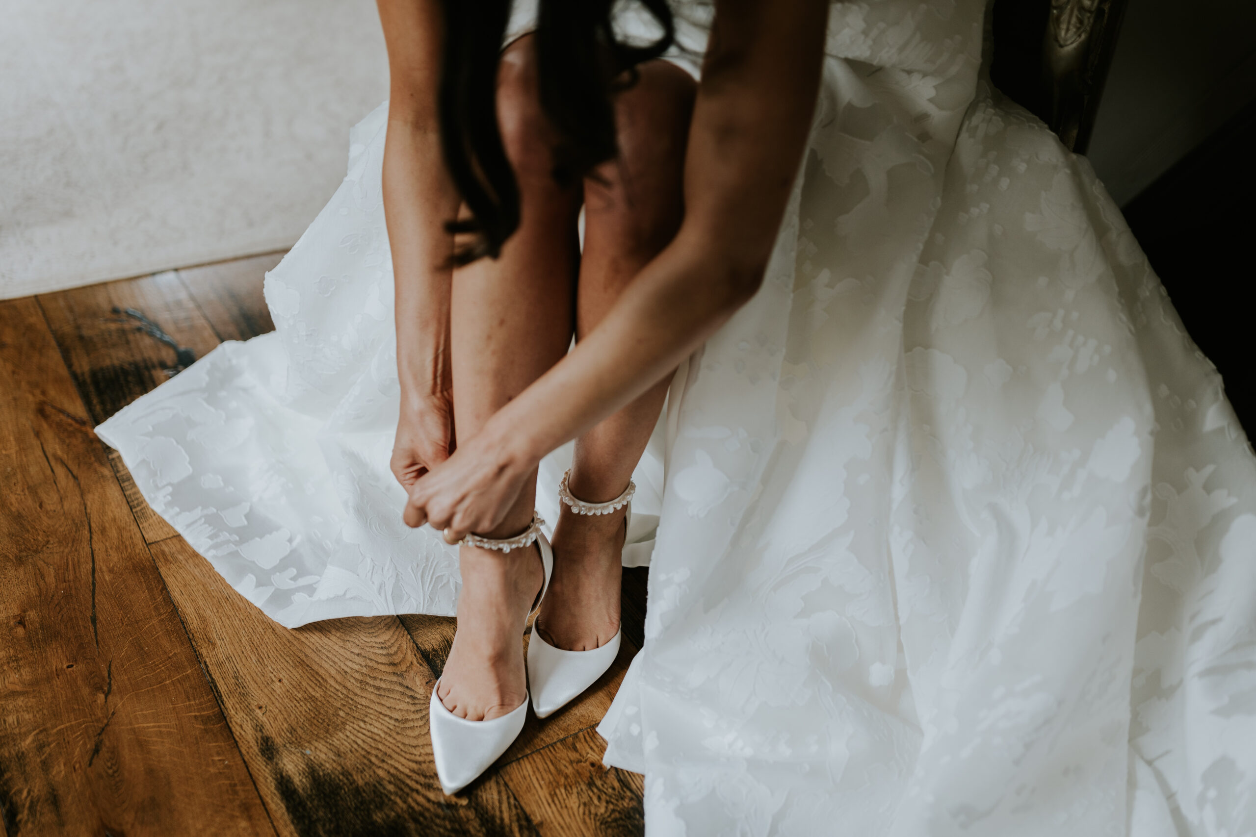 Bride doing up her shoes 