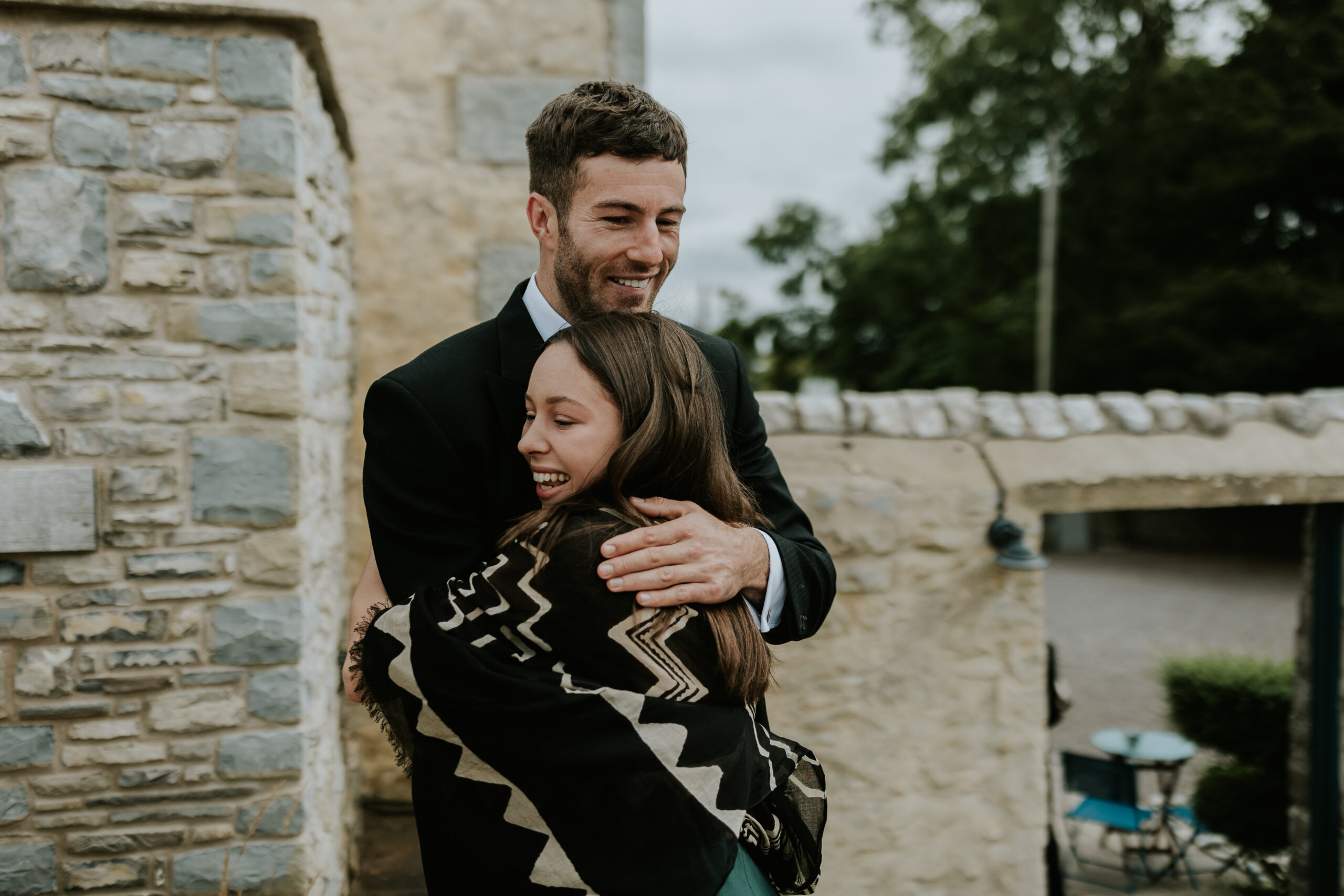 Groom hugging guest