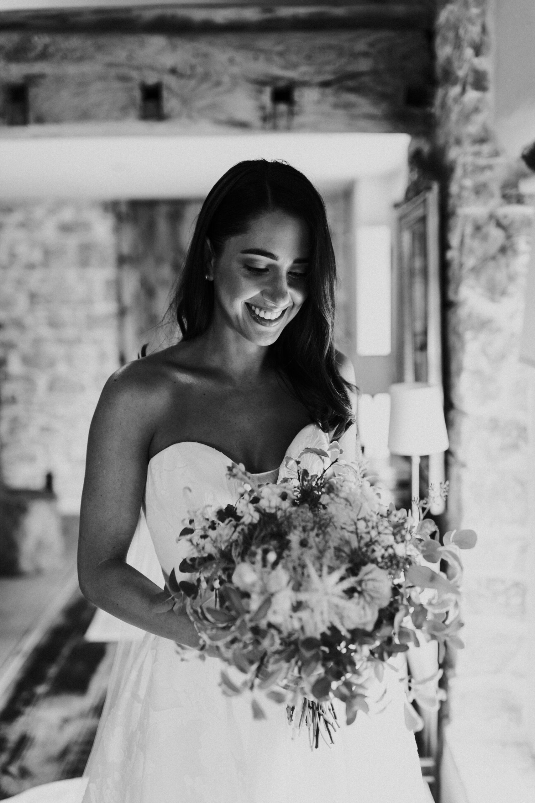 Bride smiling at her bouquet 