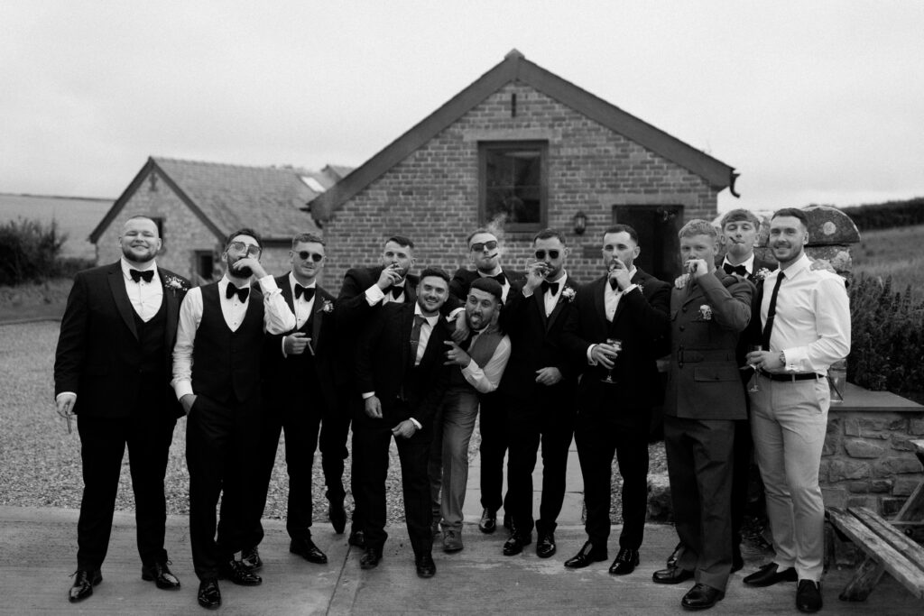 Groomsmen at Rosedew Farm smoking cigars