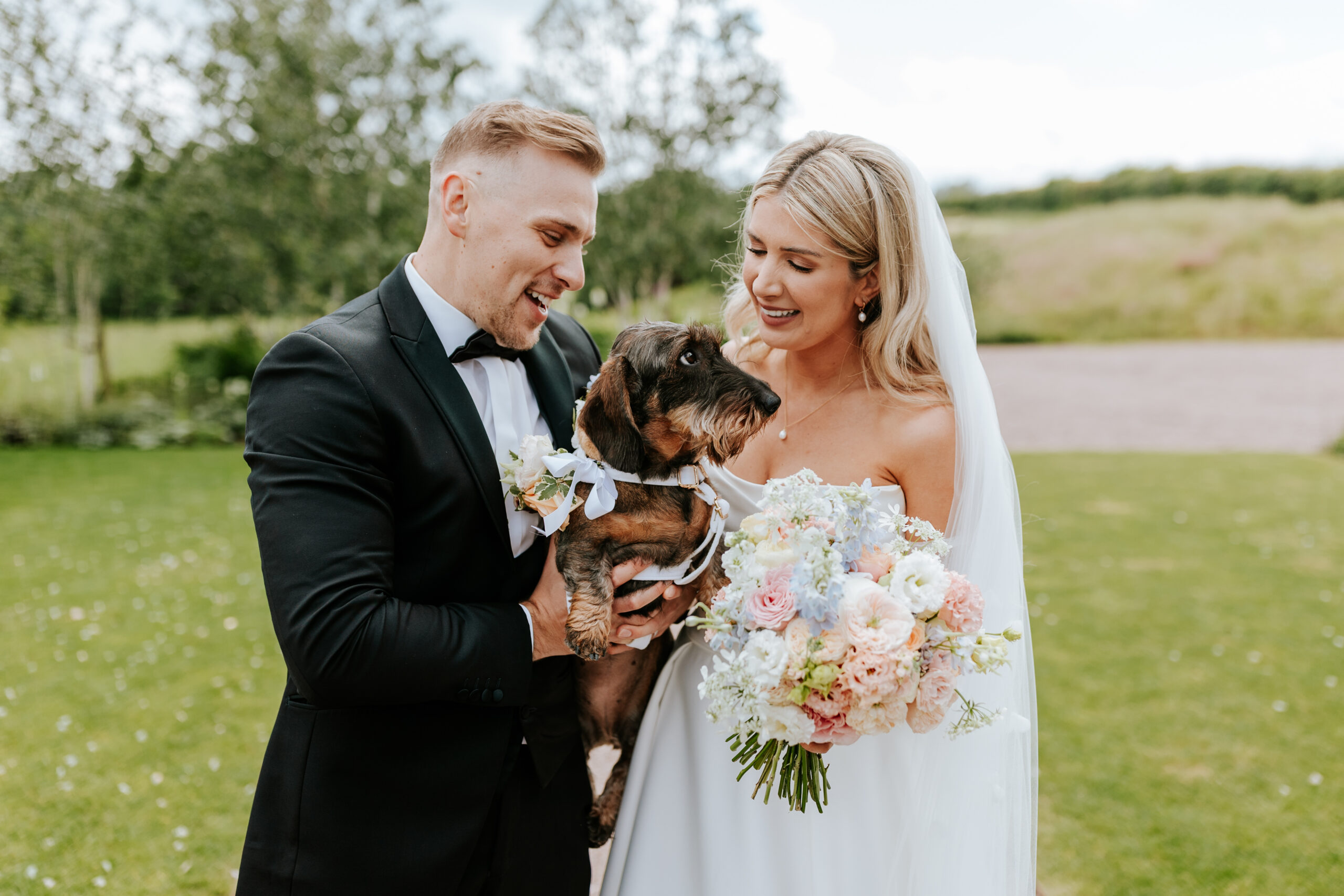 Couple kissing their dog